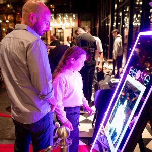 People enjoying a photo booth at an event